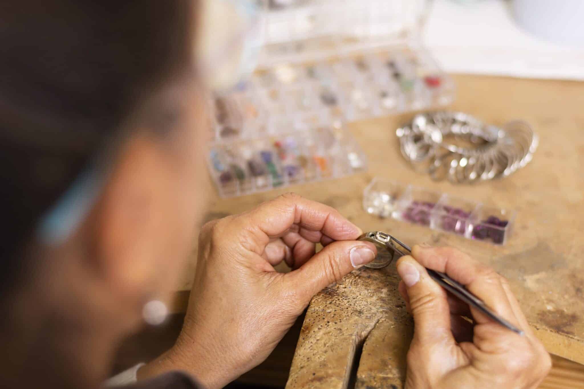 jeweler hands putting jewel ring
